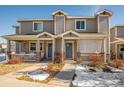 Charming townhome featuring a cozy porch, well-maintained landscaping, and a welcoming front entrance at 6105 Verbena Ct # 103, Erie, CO 80516