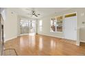 Bright living room featuring gleaming hardwood floors, sliding glass door, and many windows at 8915 Federal Blvd # 104, Denver, CO 80260