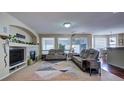 Relaxing living room with a fireplace, large windows, and comfortable seating at 1035 Cryolite Pl, Castle Rock, CO 80108