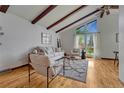 Inviting living room with hardwood floors, high ceilings, exposed beams, and ample natural light at 1821 E Kettle Ave, Centennial, CO 80122