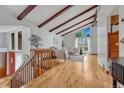 Bright living room with vaulted ceilings, exposed beams, hardwood floors, and a large window at 1821 E Kettle Ave, Centennial, CO 80122