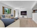 Bright living room featuring modern decor, hardwood floors, and large windows at 8705 W 86Th Dr, Arvada, CO 80005