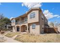 Attractive multi-story home featuring stucco siding, arched windows, and a small balcony at 4225 W 30Th Ave, Denver, CO 80212