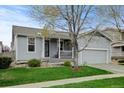 Charming single-story home with a well-manicured lawn, covered porch, and attached two-car garage at 4312 Windmill Dr, Brighton, CO 80601