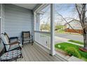 Cozy front porch featuring comfortable seating with a neighborhood view, perfect for relaxing outdoors at 4312 Windmill Dr, Brighton, CO 80601