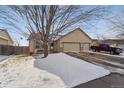 Attractive single-Gathering home featuring a two-car garage and a landscaped yard, partially covered in snow at 1025 Birch Ave, Fort Lupton, CO 80621