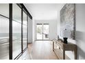 A hallway features a glass divider, hardwood floors, and a sliding glass door to the backyard at 3112 Braun Ct, Golden, CO 80401
