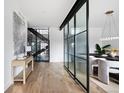 An open hallway features hardwood floors, a glass divider and staircase leading to a second level at 3112 Braun Ct, Golden, CO 80401