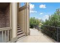 A walkway with iron railing leads to this homes private balcony and staircase with a view of the surrounding landscape at 23376 E 5Th Pl # 201, Aurora, CO 80018