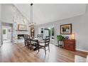 Dining room featuring a stone fireplace, hardwood floors, and grand father clock at 9053 Clydesdale Rd, Castle Rock, CO 80108