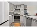 Modern kitchen with stainless steel appliances and gray cabinets at 961 S Evanston Cir, Aurora, CO 80012