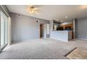 Inviting open-concept living room with plush carpeting and easy access to the kitchen at 15700 E Jamison Dr # 2-204, Englewood, CO 80112