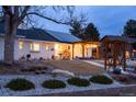 Charming ranch home with a solar panel system and well-manicured lawn at 14117 W 58Th Pl, Arvada, CO 80004