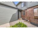 Cozy entryway featuring brick accents, a For Sale sign, and a welcoming entrance at 3596 S Depew St # 2, Lakewood, CO 80235