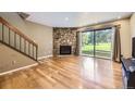 Inviting living room with stone fireplace, hardwood floors, and large sliding glass doors at 3596 S Depew St # 2, Lakewood, CO 80235