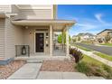 Charming front porch with dark trim, covered entry, and landscaped yard at 3692 Celestial Ave, Castle Rock, CO 80109