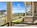 Covered front porch view with an open neighborhood street featuring lush green landscaping at 3692 Celestial Ave, Castle Rock, CO 80109