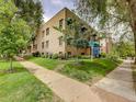 Brick apartment building showcasing mature trees, green lawn and street access at 1605 Saint Paul St # 6, Denver, CO 80206