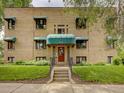 Charming brick building with green awnings, well-maintained landscaping and an inviting entrance at 1605 Saint Paul St # 6, Denver, CO 80206