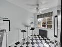 Compact kitchen area with black and white tile and bar seating at 1605 Saint Paul St # 6, Denver, CO 80206