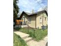 Exterior view of home with nice yard and steps to front entrance at 2200 Teller St, Lakewood, CO 80214