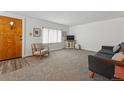Bright living room with a beautiful front door and neutral decor at 2200 Teller St, Lakewood, CO 80214