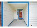 Inviting entryway featuring a red front door, sidelight window and brick accents at 12287 W Aqueduct Dr, Littleton, CO 80127