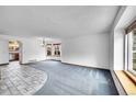 Bright living room with plush carpet, bay window, and neutral walls at 12287 W Aqueduct Dr, Littleton, CO 80127