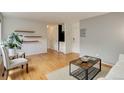 Open living room featuring beautiful wood floors, floating shelves, and modern accents at 21 N Washington St # 301, Denver, CO 80203