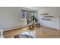Bright living space with hardwood floors, decorative shelves, and sunny windows at 21 N Washington St # 301, Denver, CO 80203