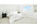 Bright bedroom featuring white walls, plush carpeting, and a serene atmosphere at 6190 W Canyon Ave, Littleton, CO 80128