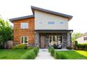 Attractive modern home with wood and gray siding, stone accents, and a welcoming front porch seating area at 4251 Perry St, Denver, CO 80212