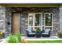 Charming front porch with stone accents, comfortable seating, and stylish decor, creating a cozy outdoor space at 4251 Perry St, Denver, CO 80212