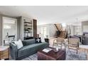 Bright and airy living room featuring modern furniture, a stylish rug, and an open staircase at 4251 Perry St, Denver, CO 80212