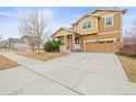 Charming two-story home with a two-car garage, a well-maintained yard, and a welcoming entrance at 844 Dakota Ln, Erie, CO 80516
