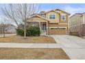 Inviting two-story home with a two-car garage, landscaped front yard, and neutral-toned exterior at 844 Dakota Ln, Erie, CO 80516