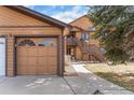 Attached garage showcases natural light and a private walkway to the home's entrance at 9077 W 88Th Cir, Denver, CO 80021