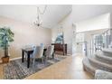 Dining area adjacent to staircase, showcasing neutral colors and easy access to the kitchen at 10978 Ashurst Ln, Highlands Ranch, CO 80130