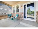 Inviting front porch with cozy seating, brick accents, and a stylish front door, perfect for relaxing at 10978 Ashurst Ln, Highlands Ranch, CO 80130