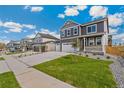 Beautiful two-story home exhibiting a three-car garage, green lawn, and well-maintained surroundings at 14249 Beebalm Ave, Parker, CO 80134