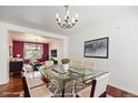 Elegant dining room featuring hardwood floors and a modern glass-top dining table at 17045 Hastings Ave, Parker, CO 80134