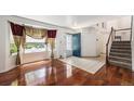 Bright foyer with hardwood floors, staircase, and stained glass accents at 17045 Hastings Ave, Parker, CO 80134
