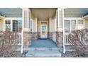 Charming front porch with stone accents, offering a welcoming entrance to the home at 16047 E Geddes Ln # 128, Aurora, CO 80016