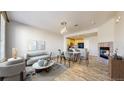 Bright living room with stylish furniture, fireplace, and open layout leading to the kitchen at 16047 E Geddes Ln # 128, Aurora, CO 80016