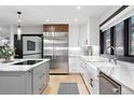 Modern kitchen featuring stainless steel appliances, custom cabinets, and an island with a cooktop at 2548 Keystone Dr, Evergreen, CO 80439