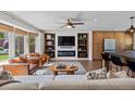 Stylish living room with a fireplace, built-in shelves, and bright natural light with comfortable seating at 7633 S Gilpin Ct, Centennial, CO 80122