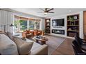 Stylish living room with a fireplace, built-in shelves, and bright natural light with comfortable seating at 7633 S Gilpin Ct, Centennial, CO 80122