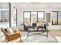 Bright living room features modern decor, large windows, and an open floor plan at 263 S Jackson St, Denver, CO 80209