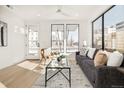 Cozy living room features a modern sofa, decor, and a large sunny window at 263 S Jackson St, Denver, CO 80209