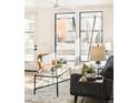 Cozy living room features a modern sofa, decor, and a large sunny window at 263 S Jackson St, Denver, CO 80209